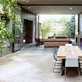 Modern Open Living and Dining Area With Wooden Table Sofa and Green Plants