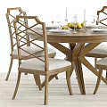 Wooden Round Dining Table Set with Upholstered Chairs Wine Glasses Plates and Lemon Bowl
