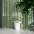 Sleek White Toilet With Modern Design Against Green Wall And Palm Leaf Shadow