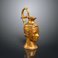 Intricate Golden Head Sculpture With Carved Facial Features Handle And Spout