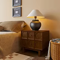Wooden Bedside Table With Lampshade And Drawers In Cozy Bedroom Near Framed Art And Pillows