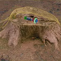 Wooden Tree Stump With Stone Ground And Power Drill Tool On Natural Surface