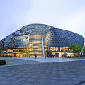Modern Architectural Building With Curved Geometric Glass Facade And Plaza With Pedestrians Trees