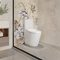 White Modern Toilet In Bathroom With Floral Mosaic Wall Wooden Cabinet And Light Stone Accents