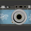 Vintage Camera With Blue Body Silver Lens And Decorative Floral Patterns