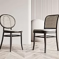 Stylish Dining Chairs With Black Frame Woven Rattan Backrest And Gray Cushion On Wooden Floor