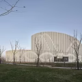 Contemporary Museum Building Featuring Circular Design And White Geometric Facade In Green Surroundings