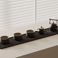 Minimalist Tea Tray Setup With Teapot And Four Cups By Window Blinds