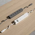 Two White Power Strips with Multiple Outlets and Curved Cords on Wooden Table 3d model