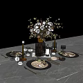 Elegant Dinnerware Set with Black Plates Gold Cutlery Wine Glasses Candle Holders and Flower Bouquet