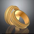 Two Stylish Gold Fashion Rings With Intricate Textured Patterns On Black Surface