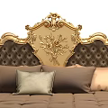 Luxurious Double Bed with Ornate Gold Carved Headboard and Brown Bedding Pillows