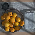 Fresh Yellow Fruits on Gray Plate with Wooden Table Gray Bowl and Gray Napkin