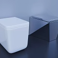 Two White and Gray Square Design Toilets Against Light Blue Wall On Dark Floor