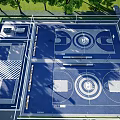 Outdoor Modern Basketball Court With Two Courts Blue Flooring White Lines And Surrounding Trees