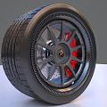 Car Tire With Alloy Wheel Rim Red Brake Calipers Silver Spokes And Gold Center Logo