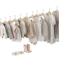 Baby Clothes Hanging on Hangers with Light Colored Dresses Shirts and Shoes