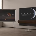 Two TVs On Stands Displaying Scenic Visuals With Wooden Soundbar In Living Room