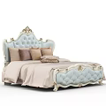 Luxurious Light Blue Tufted Double Bed with Gold Accents and Beige Pillows