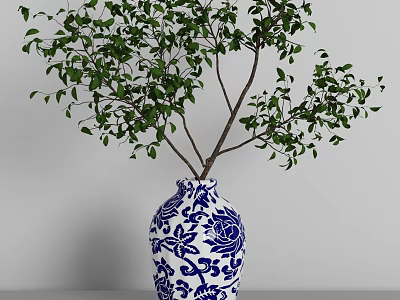 Blue and White Floral Patterned Vase with Green Leafy Branches for Home Decor 3d model