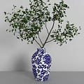 Blue and White Floral Patterned Vase with Green Leafy Branches for Home Decor
