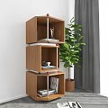 Three Tier Wooden Shelving Unit With Books Magazines Cup And Green Plant Near Grey Curtains