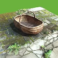 Handmade Rustic Wicker Basket Placed On Outdoor Moss Covered Stone Path