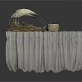 Gray Cloth Covered Table With Decorative Sailboat Model And Woven Basket