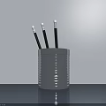 Silver Striped Metal Pen Holder With Black Pens White Tips On Gray Desktop