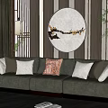 Green Three Seater Sofa With Decorative Pillows On Wooden Wall Circular Painting And Floor Lamp