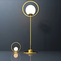 Two Modern Golden Table Lamps With Circular Design And White Globe Shades On Smooth Surface
