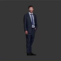 Man in Blue Suit With Glasses Standing With Hands in Pockets Against Gray Background