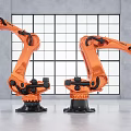 Two Orange Industrial Robotic Arms in Modern Factory Setting for Automation Manufacturing