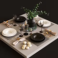 Tableware Set with Black White Plates Wine Glasses Golden Cutlery Green Plant and Candles