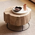 Tree Stump Wooden Coffee Table With Black Metal Base White Tray Nuts And Orange Cup