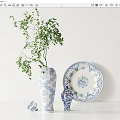 Elegant Blue and White Patterned Vase With Green Foliage Decorative Plate And Ornament