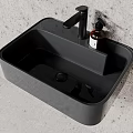 Sleek Black Bathroom Sink With Matte Surface And Modern Faucet On Textured Wall