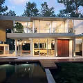 Modern Detached Villa With Glass Walls Swimming Pool And Wooden Terrace Among Trees