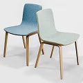 Modern Round Wooden Table With White Legs And Four Colored Upholstered Chairs
