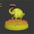 Cartoon Style Yellow Elephant Figurine With Red Object On Trunk And Green Grass Base