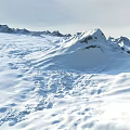 Snowy Mountain Landscape With Vast Snowfield Sunlit Peaks And Alpine Scenery