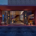 Modern Open Café Interior Featuring Glass Doors Night View Lighting Bookshelves Tables And Chairs