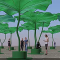 Giant Green Lotus Leaf Art Installation With People Walking Around Public Space