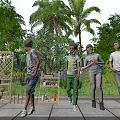 Group of children walking in outdoor garden with palm trees green plants and flower trellis