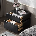 Black Leather Nightstand With White Vase Pink Flowers And Open Magazine By Bed