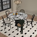 Round Marble Dining Table Set With Four Chairs And Decorative Items On Black White Rug