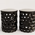 Two Black Stools With Hexagonal Cutout Design And Light Colored Padded Top 3d model