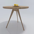 Wooden Round Coffee Table with Three Legs and White Plate with Two Lemons