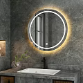 Round LED Illuminated Bathroom Mirror on Gray Wall with Modern Faucet and Decorative Plant