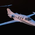 White Passenger Jet Flying In Clear Blue Sky With Sleek Wings And Windows